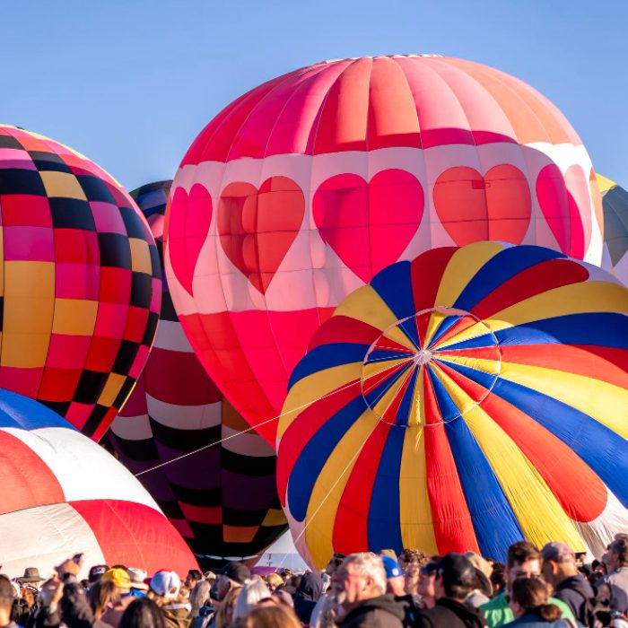 colorful-balloons-inflate-against-blue-sky-while-spectators-watch-albuquerque-new-mexico-2022 (1)